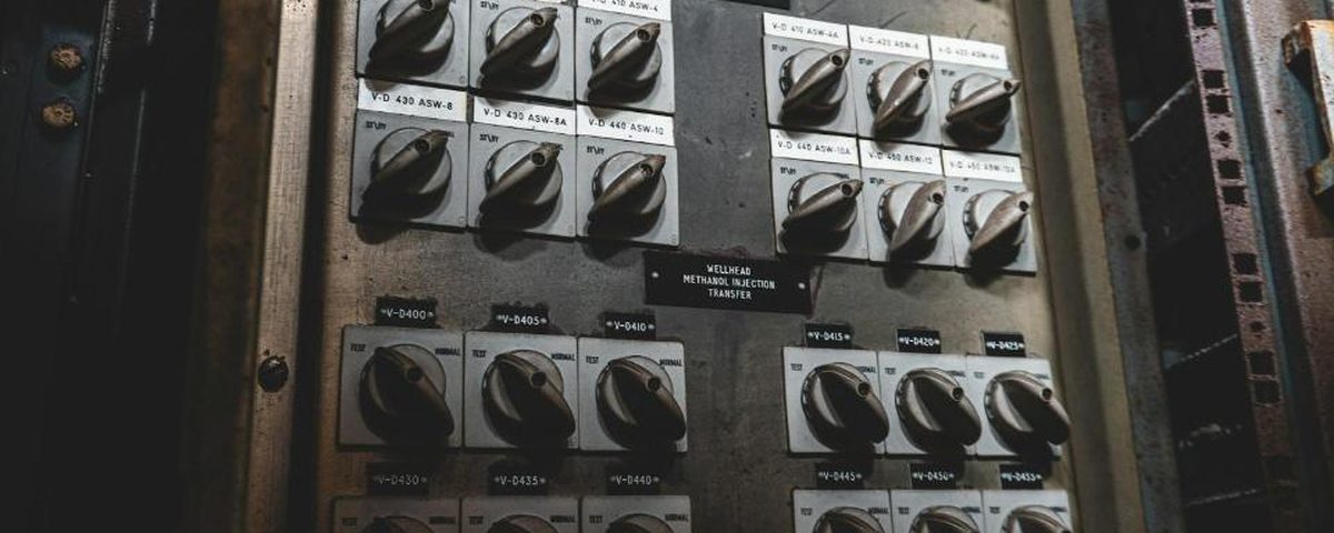 Industrial control panel with labeled switches and indicator lights
